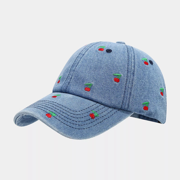 Side view of blue denim baseball cap with cherry embroidery