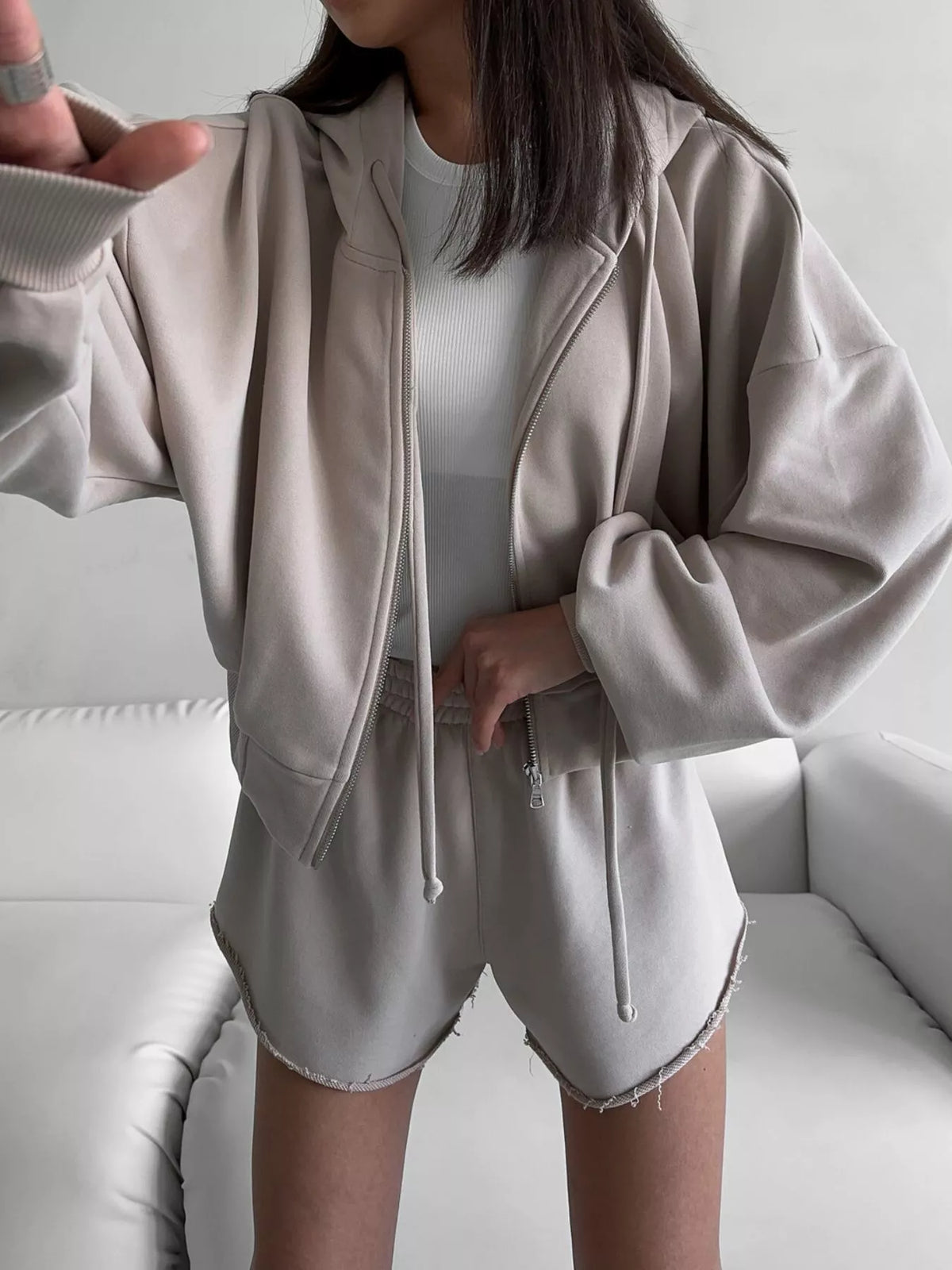 Front view of taupe hoodie and shorts with a white sleeveless top