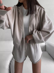 Front view of taupe hoodie and shorts with a white sleeveless top