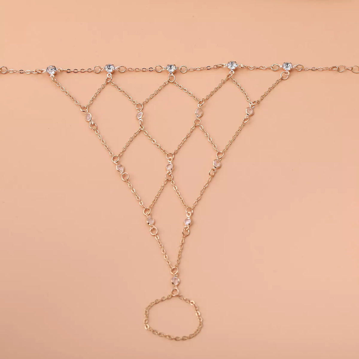 Gold-tone hand chain laid flat, showing the connected diamond-shaped links