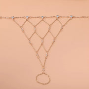 Gold-tone hand chain laid flat, showing the connected diamond-shaped links