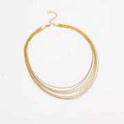 Silver-tone multi-strand necklace arranged on fabric