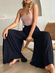 Close view of navy wide-leg pants draped over a chair