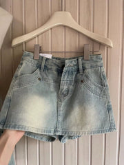 Front view of light-wash high-waisted denim shorts on hanger