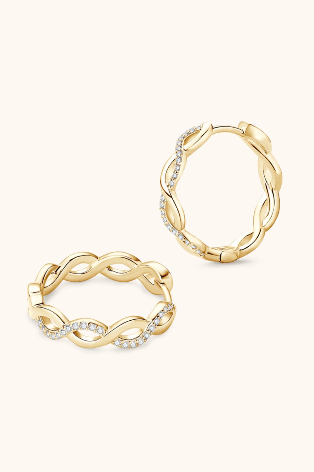 Pair of gold-tone crisscross hoop earrings with clear stone accents, front view