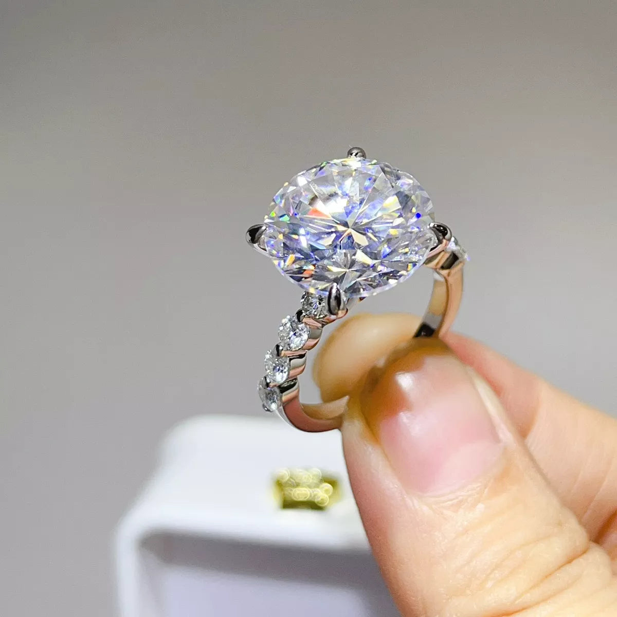 Side view of raised round moissanite and silver band