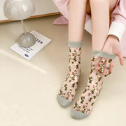 Dark floral sheer socks with black cuffs and toes worn with black shoes