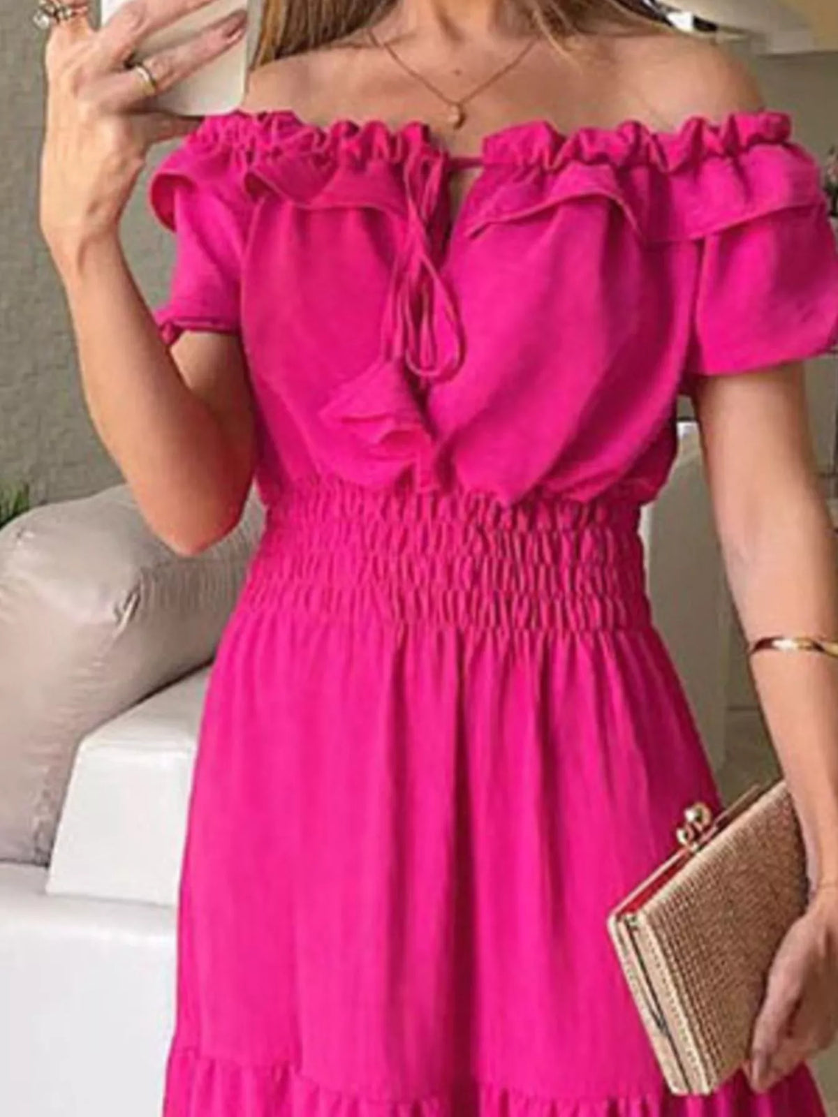 Close view of rose-red dress bodice with ruffled neckline and gathered waist