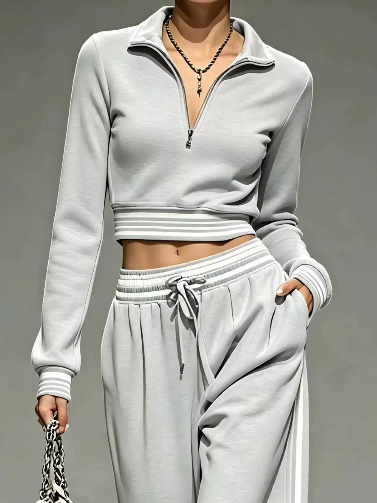 Woman modeling light gray cropped half-zip top and matching pants