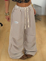 Front view of brown-and-cream vertically striped pants with elastic waist and drawstring