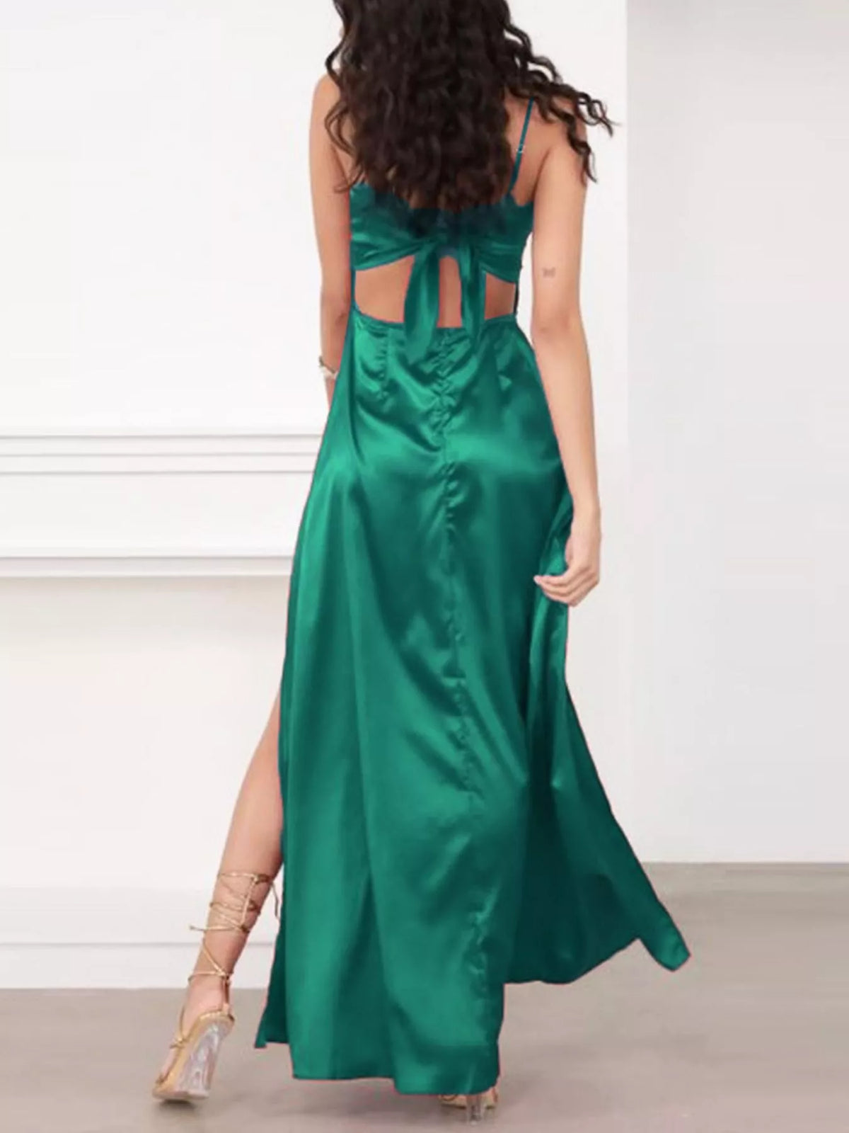 Rear view of green maxi dress showing open back and tied strap detail