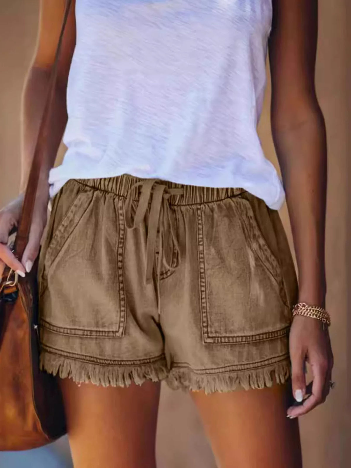 Brown drawstring denim shorts with front patch pockets and frayed hems