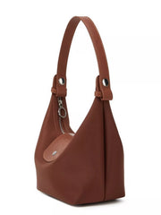Side profile of the brown shoulder bag showing its deep gusset and short handle.