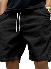 Model wearing black drawstring shorts
