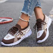Brown mesh sneaker with cream geometric panels, close side view