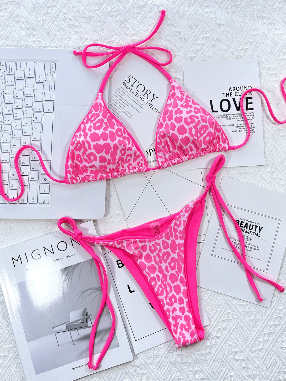 Pink leopard bikini set laid flat with matching tie straps