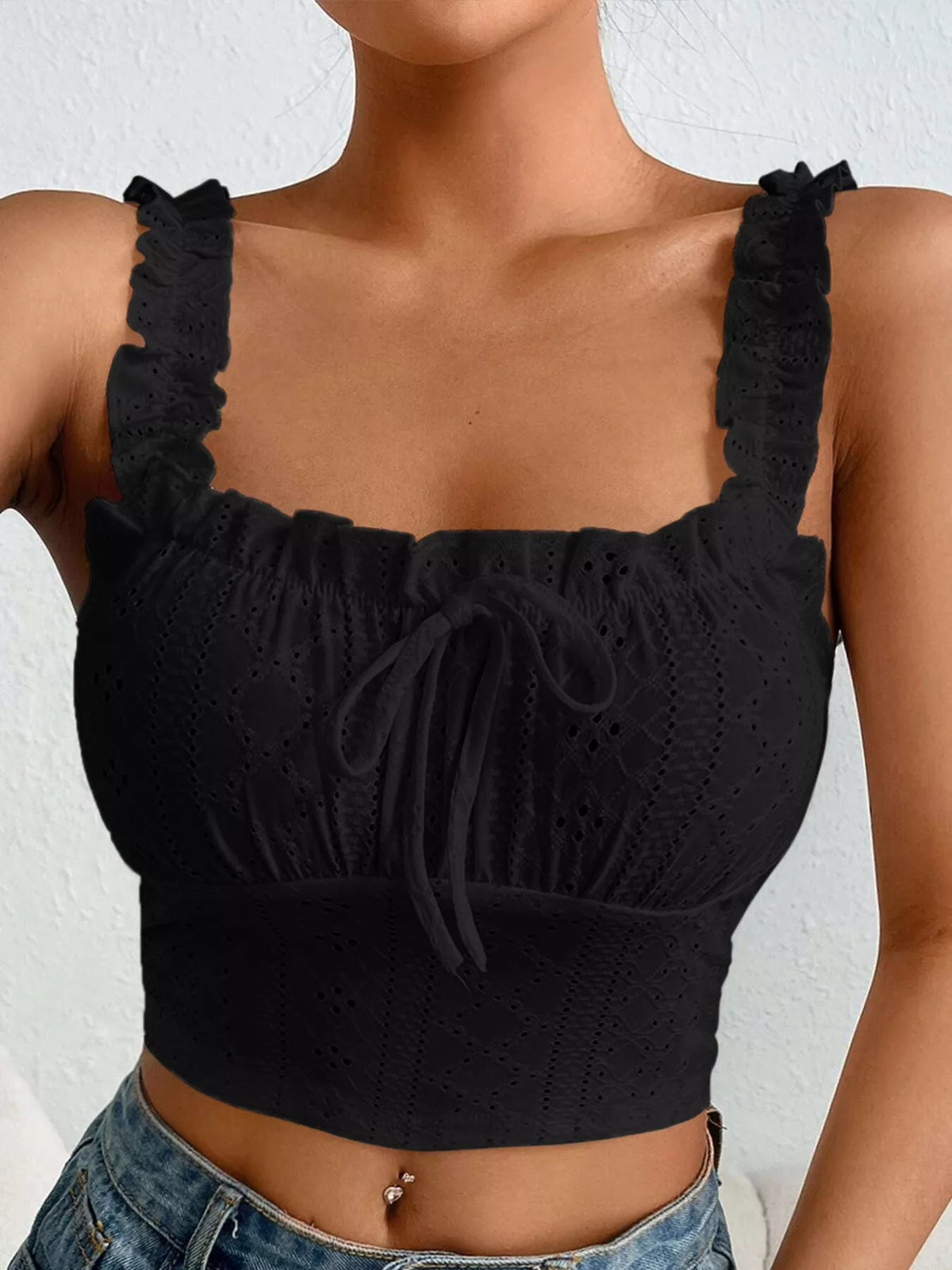 Back view of black crop tank with wide eyelet panel and ruffled straps