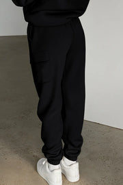 Side view of black joggers showing cargo pocket and elastic cuffs