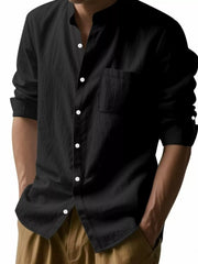 Close view of the black long-sleeve button-up shirt with white buttons and chest pocket