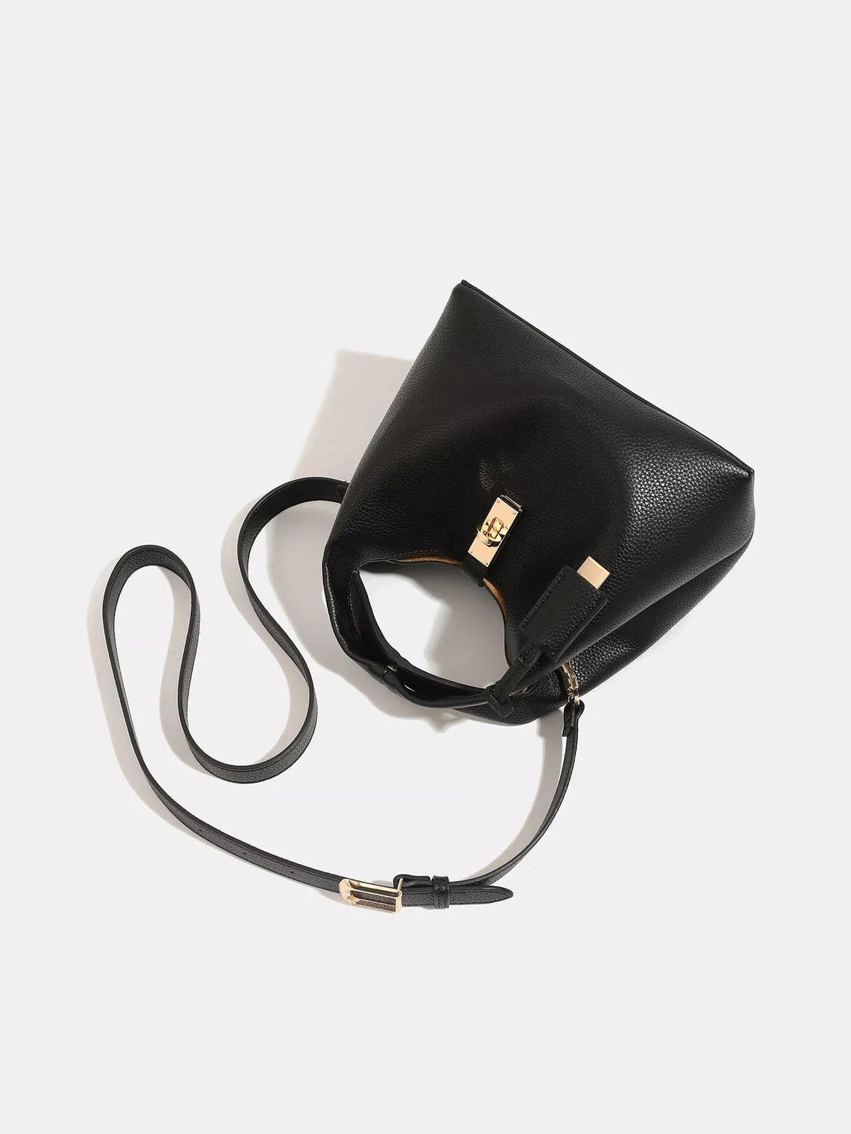 Top-down view into the black handbag showing its brown-lined interior