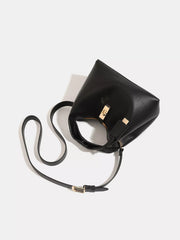 Top-down view into the black handbag showing its brown-lined interior