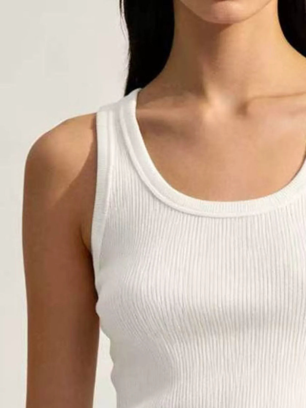 Close-up white tank ribbing and rounded neckline