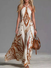 White halter-neck printed maxi dress with brown pattern, front view and high slit