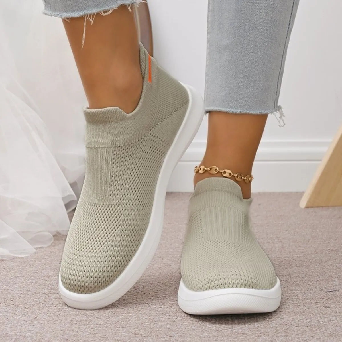 Pair of sage green mesh sneakers, front view