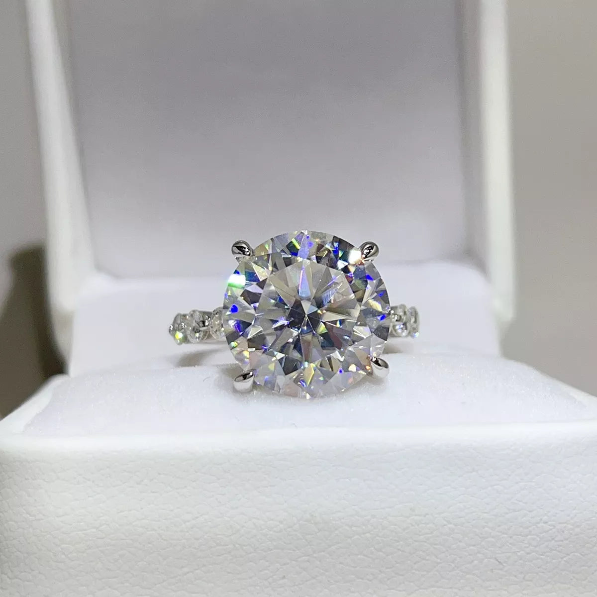 Clear round moissanite ring displayed in an open white jewellery box