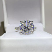 Clear round moissanite ring displayed in an open white jewellery box