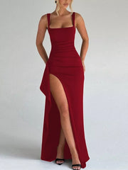 Front view of the red sleeveless ruched maxi dress with a high slit.