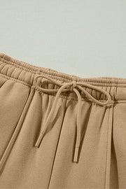 Close-up of tan pants showing gathered drawstring waistband.