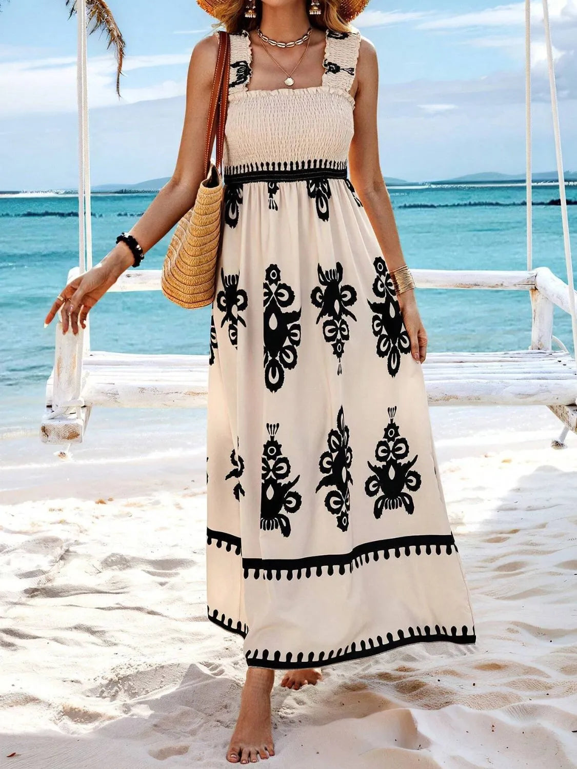 Model wearing cream and black printed smocked maxi dress