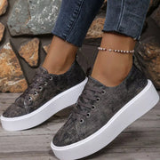 Angled front view of charcoal patterned platform sneakers worn with cropped jeans