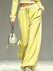 Yellow matching pants showing elastic waist, drawstring and pocket