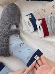 Light blue cartoon-print crew sock worn on foot