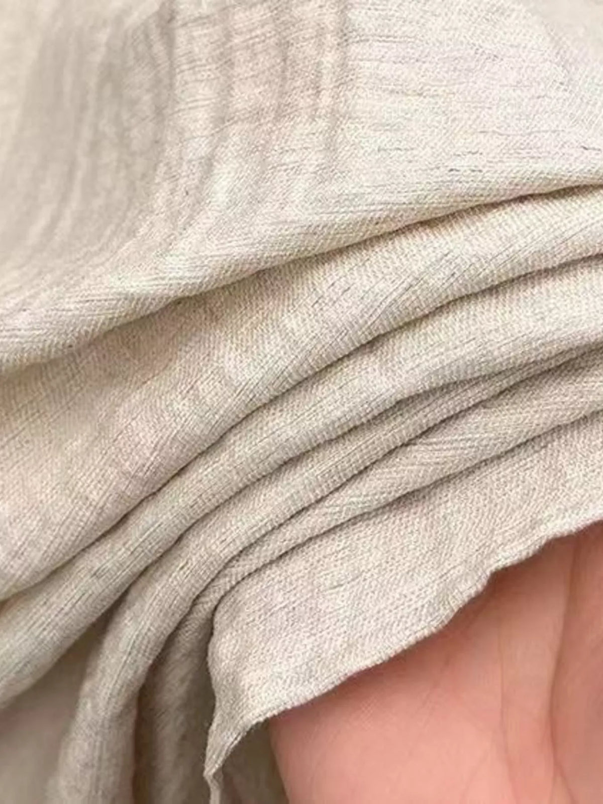 Close-up of the cream shirt’s woven slub texture