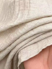 Close-up of the cream shirt’s woven slub texture