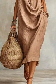 Tan draped midi dress showing gathered folds and a side pocket