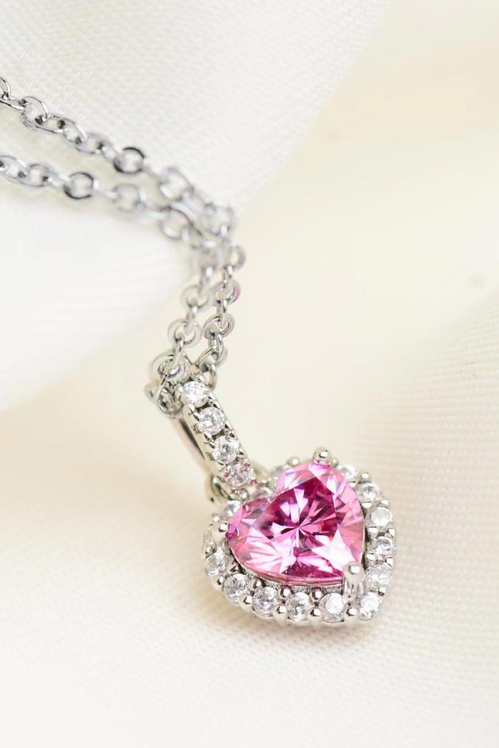 Pink heart-cut moissanite pendant with halo on silver-tone chain