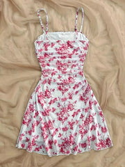 Pink floral spaghetti-strap mini dress laid flat, full front