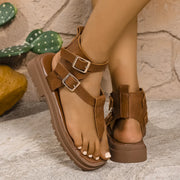 Brown toe-post platform sandals with double buckled straps and lugged soles