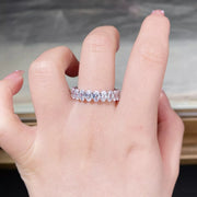 Clear stone silver band worn on a hand.
