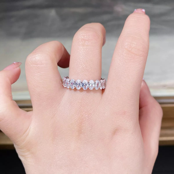 Clear stone silver band worn on a hand.
