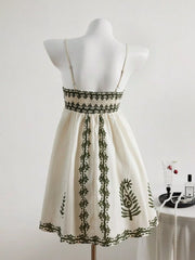 Back view showing embroidered waistband on ivory sleeveless dress
