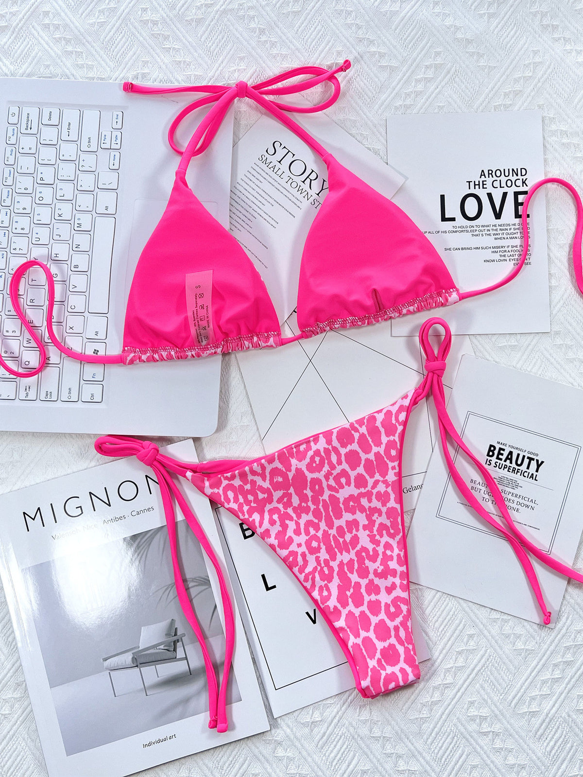 Pink halter bikini set displayed flat on printed paper