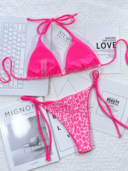 Pink halter bikini set displayed flat on printed paper