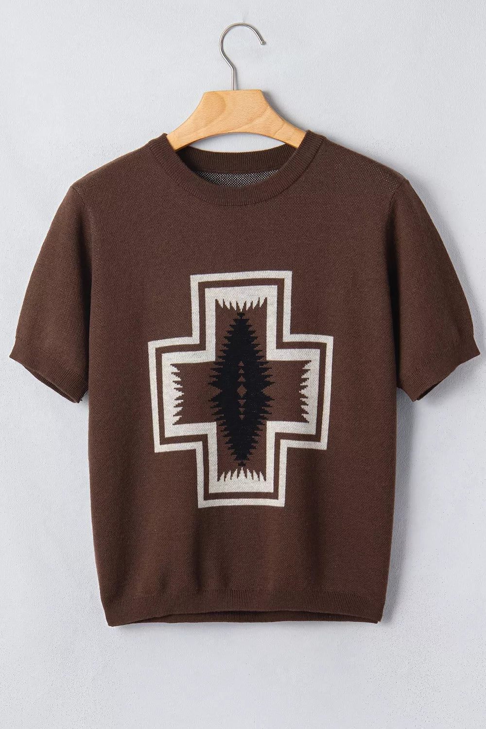 Brown short-sleeve tee with large western cross graphic displayed on a hanger