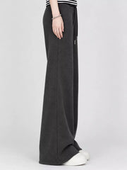 Side view of black wide-leg flare pants with an elastic drawstring waist