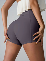 Rear angled view of plum fitted active shorts with a wide waistband.